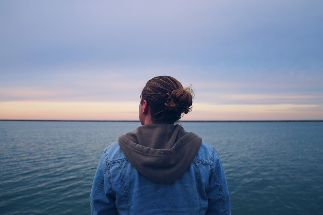 person looking at horizon thoughtfully