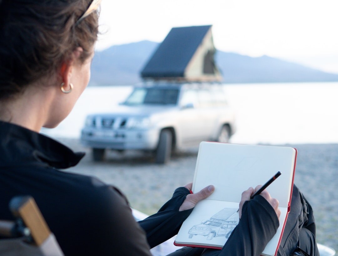 woman writing in notebook outdoors